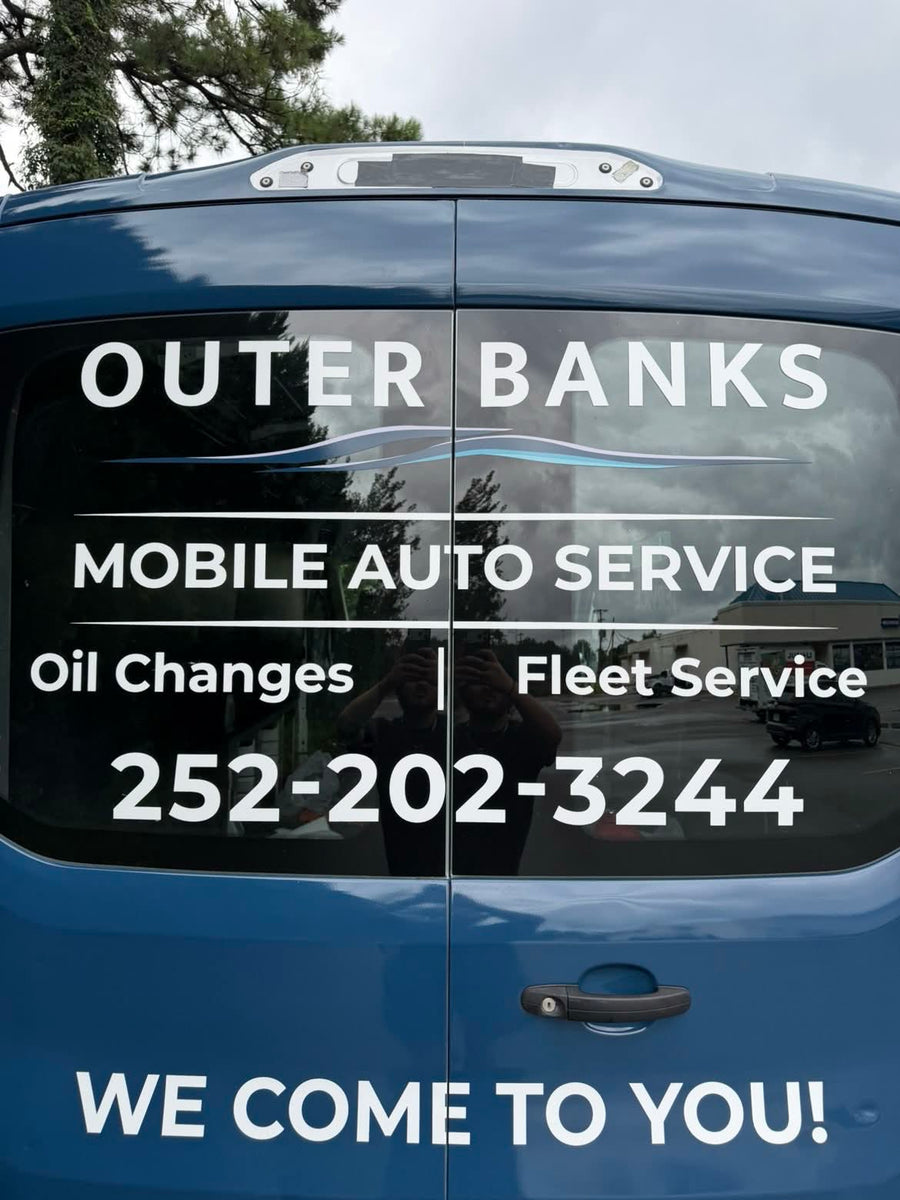 Rear doors of the wrapped van with window lettering and phone number